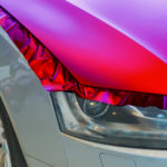 violet vinyl wrap installation on car hood