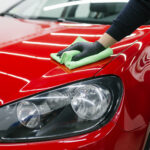 man cleaning car with microfiber cloth