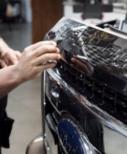 close up of paint protection film being applied to the front of a ford f350 at G-Force Films